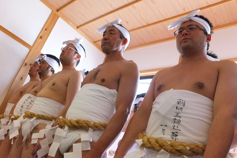 遙拝殿の玄関で参拝する裸男たち